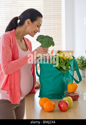 Pregnant woman unpacking groceries Stock Photo