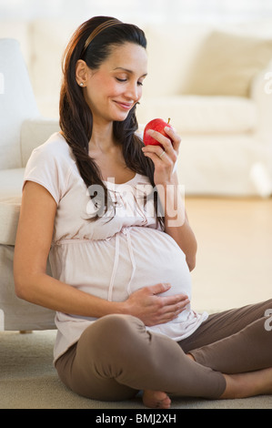 Pregnant woman eating an apple Stock Photo