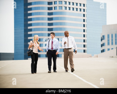 Co-workers walking in parking lot Stock Photo