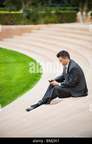 Businessman sitting on steps Stock Photo