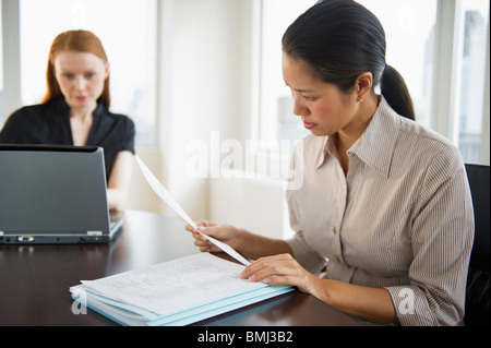 Businesswomen working in conference room Stock Photo