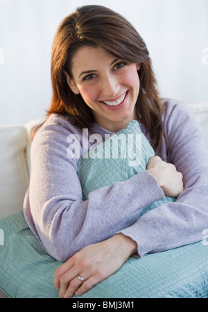 Woman hugging a pillow Stock Photo