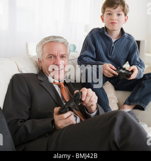 Father and son playing video game Stock Photo