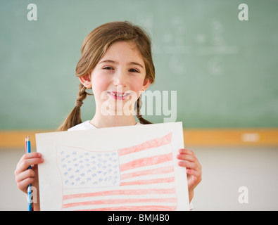 Child holding drawing of American flag Stock Photo