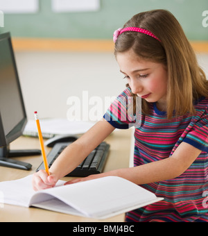 Student writing in notebook Stock Photo