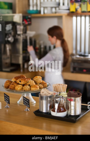 Woman working in coffee shop Stock Photo
