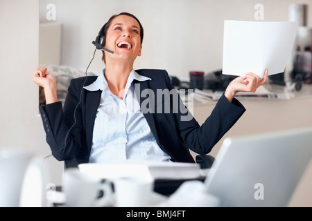 Businesswoman laughing while wearing headset Stock Photo