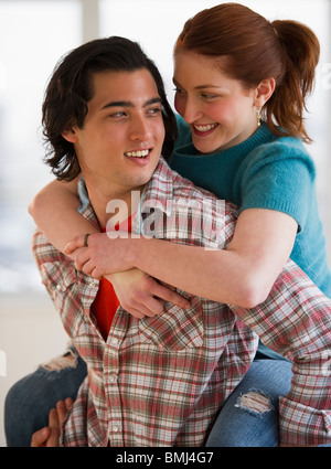Man giving woman a piggy back ride Stock Photo