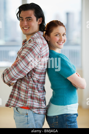 Couple standing back to back Stock Photo