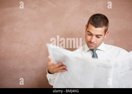 Businessman reading newspaper Stock Photo