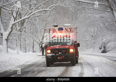New York City fire department vehicle driving on snowy road Stock Photo