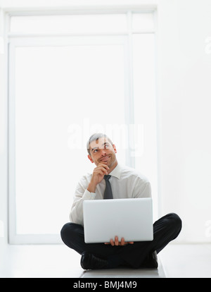 Businessman holding laptop Stock Photo