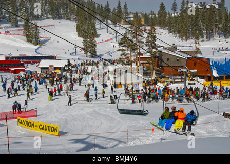chairlift crowds excitement colorful skiing sport Winter scene athletic athlete poles North Lake Tahoe skis California USA Stock Photo