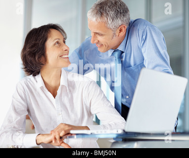 Colleagues working on laptop Stock Photo