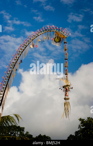 Long decorative bamboo poles, locally known as 'penjor' constructed when Balinese Hindus celebrate Galungan and Kuningan Day. Stock Photo