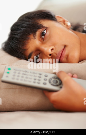 Young woman holding remote control Stock Photo