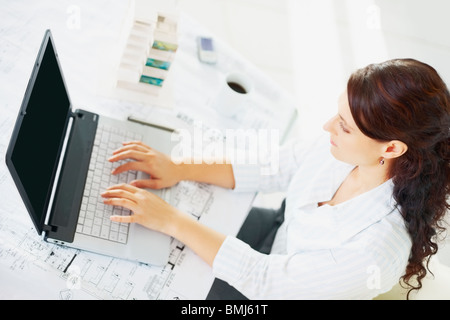 Woman typing on laptop Stock Photo