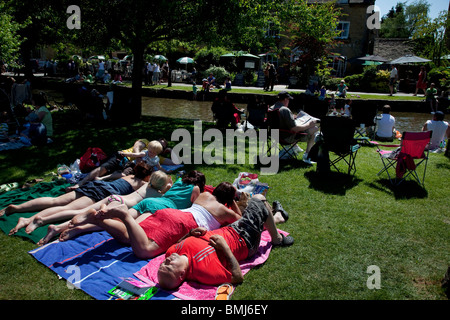 Crowds of visitors at Bourton-on-the-Water in The Cotswolds, Gloucestershire, UK. Stock Photo