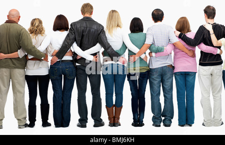 group of people with their arms around each other's backs Stock Photo