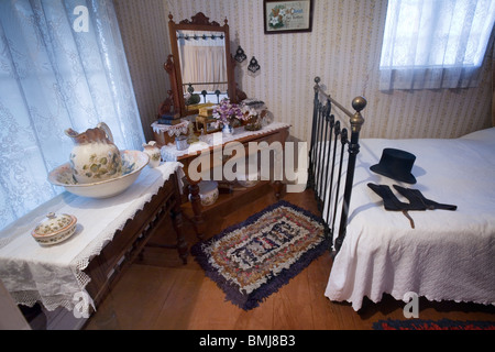 A nineteenth (XIX) century (1800s) bedroom with a vanity mirror and ...