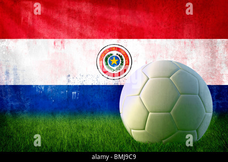 Grunge Paraguay flag on wall and soccer ball Stock Photo