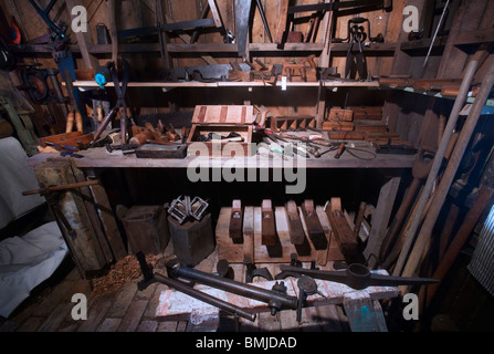 A nineteenth (XIX) century (1800s) work bench with saws, planers, hammers and many carpentry tools, Auckland, New Zealand Stock Photo