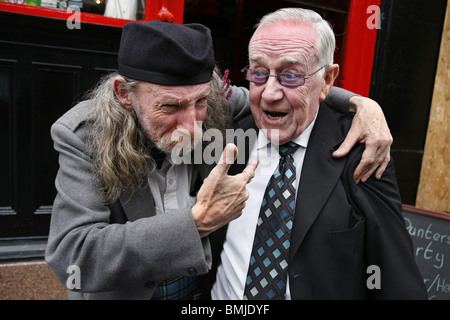 Two Friends outside a Pub, Glasgow, Scotland Stock Photo