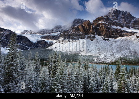 Mount Crowfoot & the Crowfoot Glacier above Bow Lake in the snow, Icefields Parkway, Banff National Park, Alberta, Canada Stock Photo