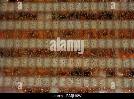 Building seen through a window with raindrops Stock Photo