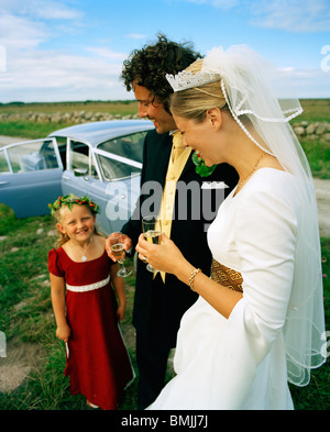 Scandinavia, Sweden, Oland, Bride and groom with flower girl, smiling Stock Photo