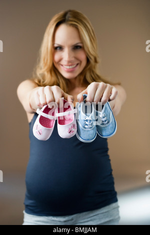 Woman showing baby shoes Stock Photo