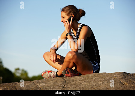 Young female runner relaxing, Sweden. Stock Photo