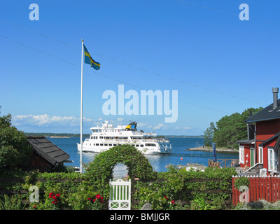 Scandinavia, Sweden, Stockholm, Sandhamn, View of ferry on sea with Swedish flag on foreground Stock Photo