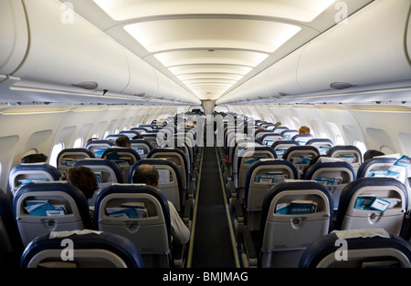 The cabin aisle on a Clickair / Click Air Airbus A320-200 passenger aircraft during flight to London from Seville, Spain. Stock Photo