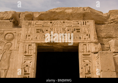 Egypt, Luxor, West Bank, Medinet Habu Temple (aka Djanet). Highly carved hieroglyphic covered wall detail. Stock Photo