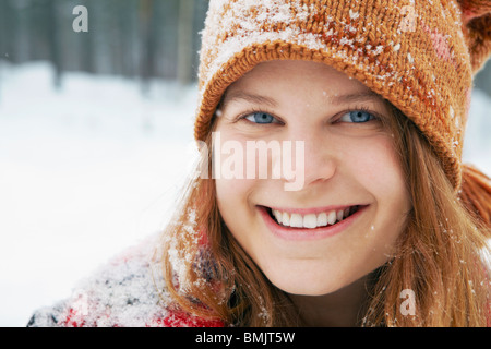 Smiling young woman in snow Stock Photo