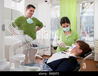 Dentist with patient in surgery Stock Photo