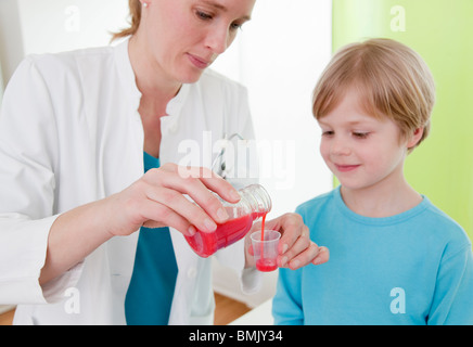 Doctor giving boy medicine Stock Photo