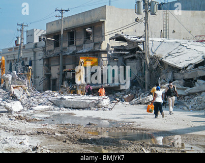 People walk through the destroyed center of Port au Prince after the Haiti earthquake Stock Photo