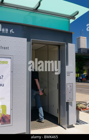Man entering first new modern automated public pay toilet on the Toronto waterfront Stock Photo