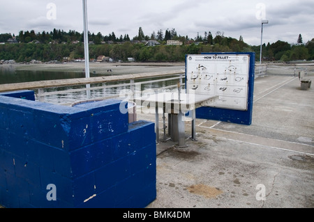 Fish cleaning station located on the Des Moines fishing pier in Des Moines, Washington on Puget Sound. Stock Photo