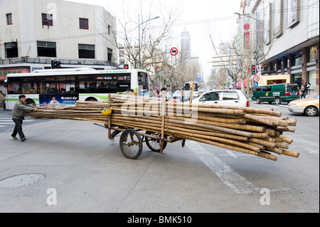 Bamboo scaffolding cart being pushed along Huaihai Road, Shanghai, China Stock Photo