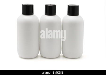Three white plastic bottles arranged in a row on white background Stock Photo