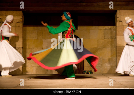 Whirling dervish performing a Sufi dance at the Al-Ghouri Mausoleum at night, Cairo, Al Qahirah, Egypt Stock Photo