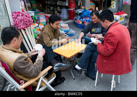 Men playing game of cards in the Old City, Shanghai, China Stock Photo