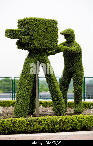 Vintage BBC cameraman / camera represented in box hedge topiary at Wimbledon tennis tournament championship ground. London. UK Stock Photo