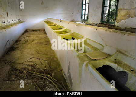 Derelict washrooms in the military barracks of Fortress La Mola, Menorca, Spain Stock Photo