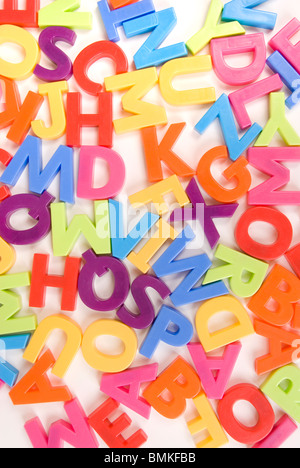 Brightly Colored Childrens Toy Magnetic Alphabet Letters on White Background Stock Photo
