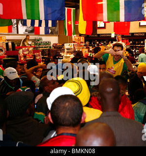 South African soccer fans queue to enter a liquor store after their team equalised Mexico in the opening match, 2010 World Cup Stock Photo