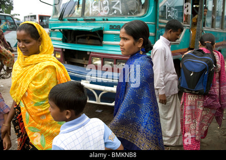 Muslim woman with son on the street near bus ; Dhaka ; Bangladesh Stock Photo